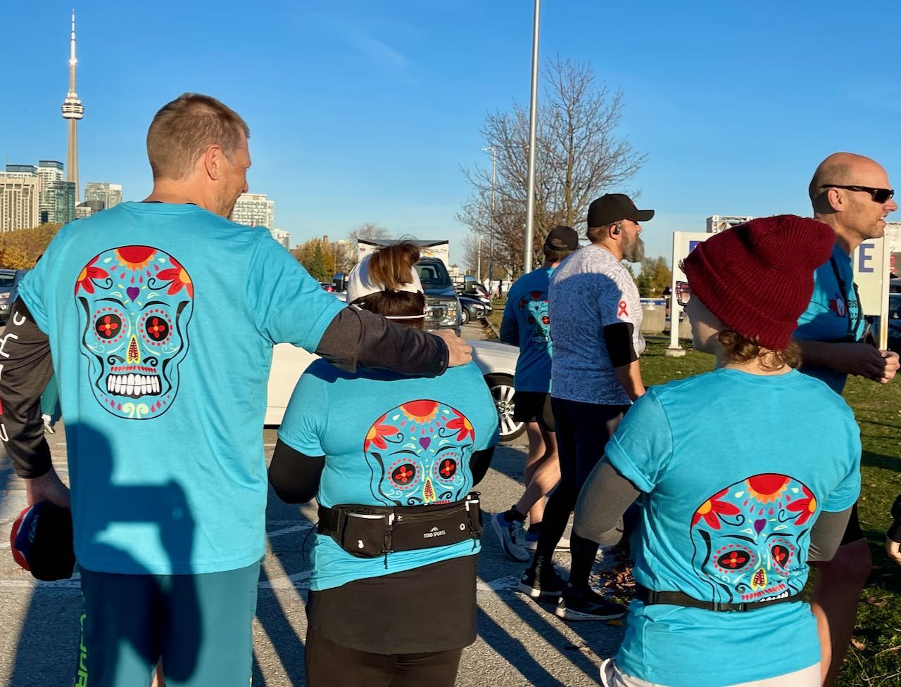 Showing off the backs of our custom running shirts before the Toronto Day of the Dead Race